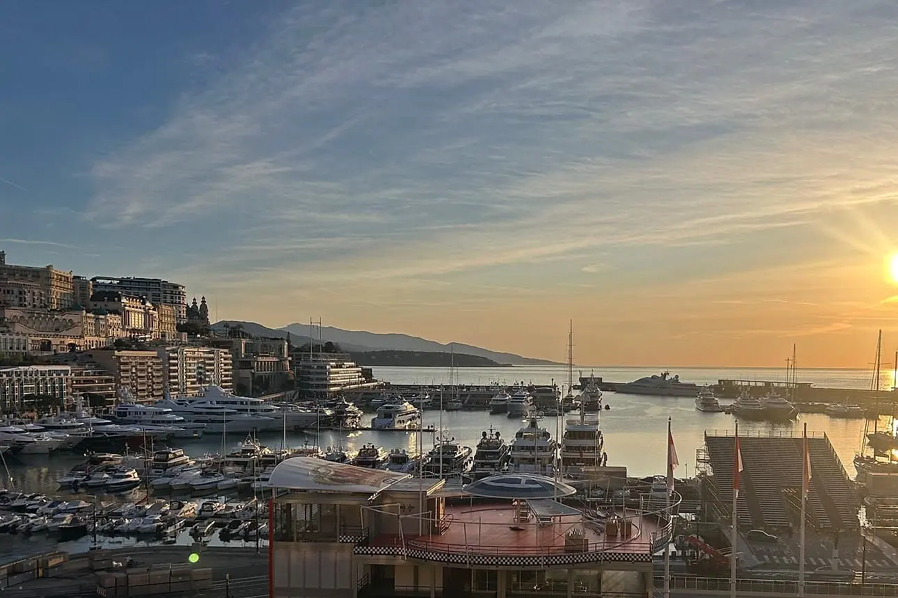 The harbour seen from a terrace on a winter afternoon, the sun low over the sea.